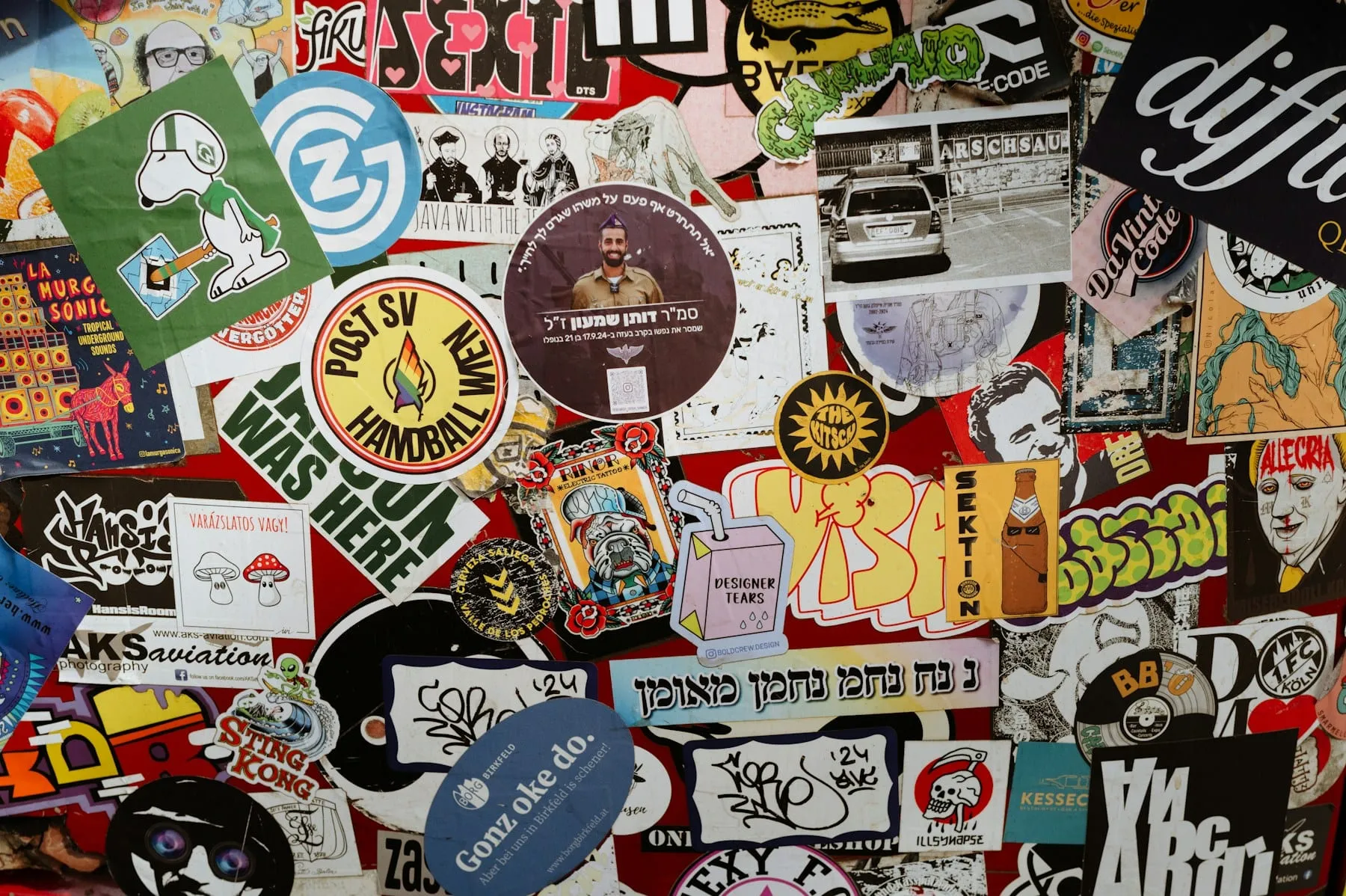 A colorful collection of stickers on a red background